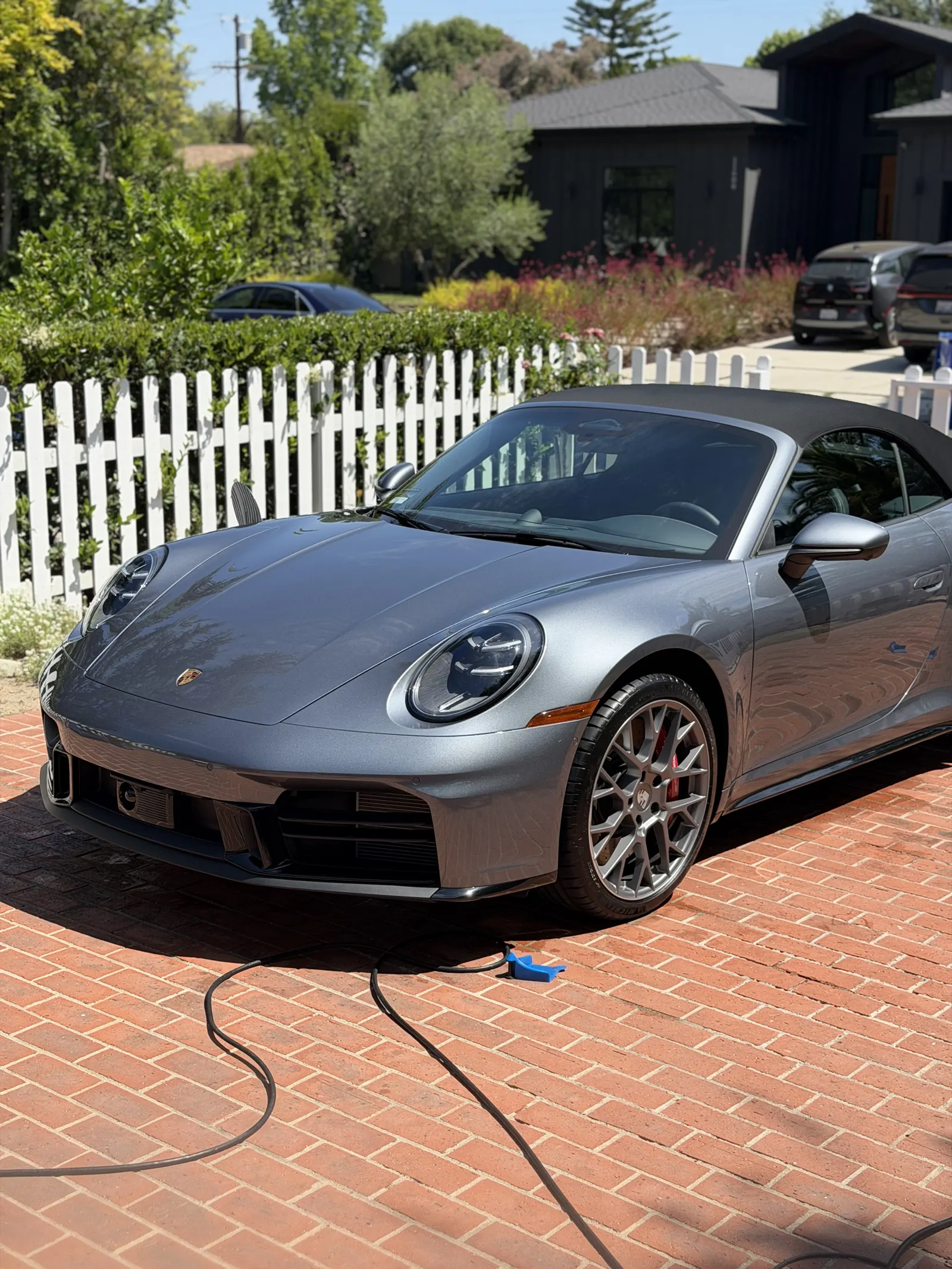 Grey Porsche 911 Cabriolet on a brick driveway after a Platinum Clean